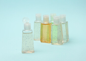 Antiseptic bottles on blue background close up.