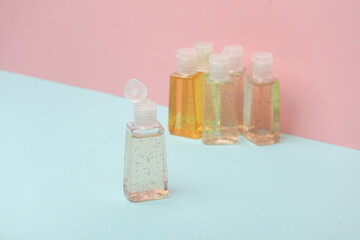 Antiseptic bottles on pink blue background. Creative layout