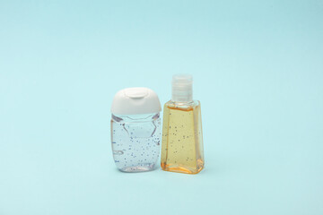 Antiseptic bottles on blue background close up.