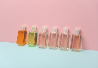 Antiseptic bottles on pink blue background. Creative layout