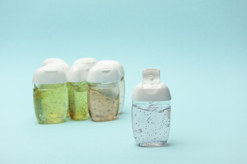 Antiseptic bottles on blue background close up.