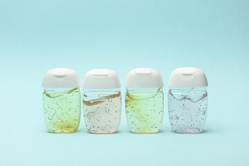 Antiseptic bottles on blue background close up.