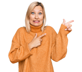 Middle age caucasian woman wearing casual winter sweater pointing aside worried and nervous with both hands, concerned and surprised expression