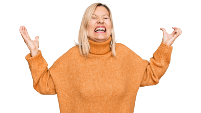 Middle age caucasian woman wearing casual winter sweater crazy and mad shouting and yelling with aggressive expression and arms raised. frustration concept.