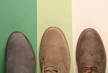 Different casual men's shoes on a colored background. Top view. Creative fashion layout