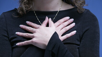 Close-up woman putting hands on chest heartwarm gesture. Gratitude concept
