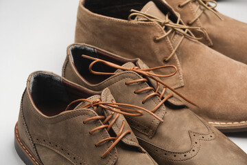Brogue shoes and desert boots closeup on a white background