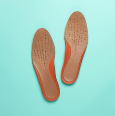 Leather insoles on a blue background