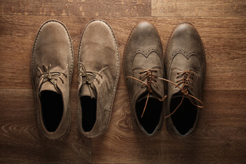 Brogues and desert shoes on a wooden background. Men's style. Top view