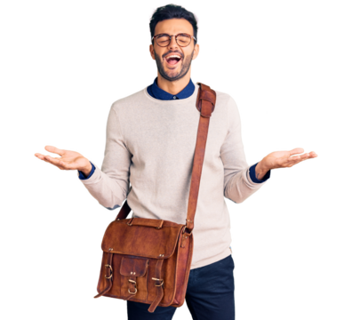 Young handsome hispanic man wearing leather bag celebrating mad and crazy for success with arms raised and closed eyes screaming excited. winner concept