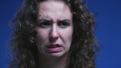 Close-up face of woman feeling disgust and contempt. 20s person feeling strong aversion, rejecting...