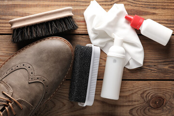 Brogue shoes with Shoe care products and accessories on a wooden background