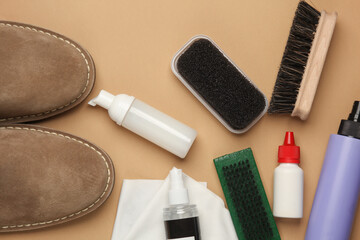 Suede shoes with Shoe care products and accessories on beige background