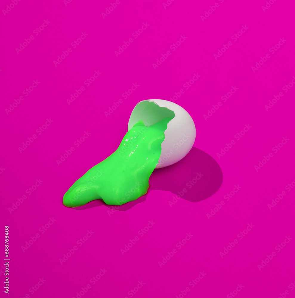 Poster creative layout with pink slime in broken chicken egg shell. bright pink background with shadow. vis