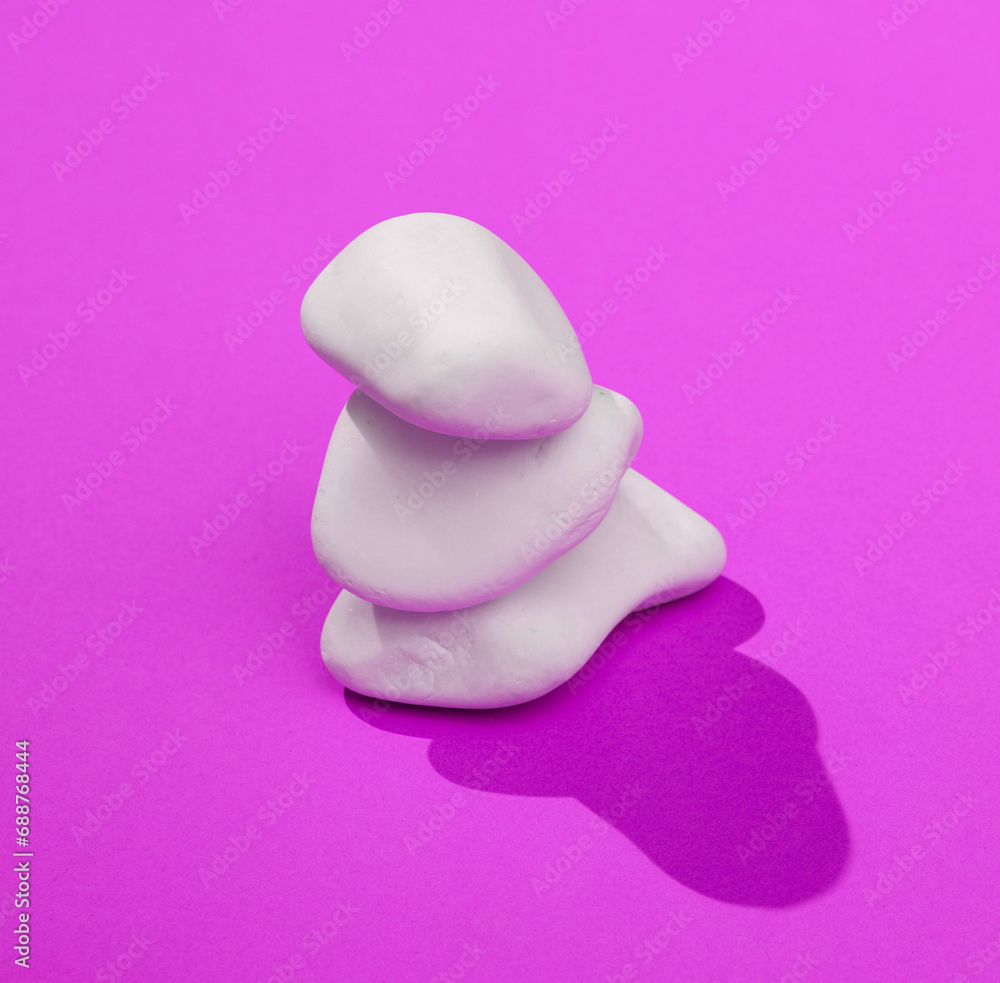 Poster creative layout with stack of pebbles. bright purple background with shadow. visual trend. harmony c