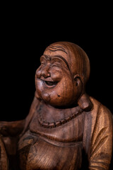 Fototapeta na wymiar Wooden Buddha with black background 