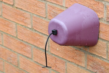 Outside faucet cover to protect from rain and freezing temperatures.  Garden tap cover. Front view.