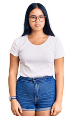 Fototapeta premium Young beautiful asian girl wearing casual clothes and glasses depressed and worry for distress, crying angry and afraid. sad expression.