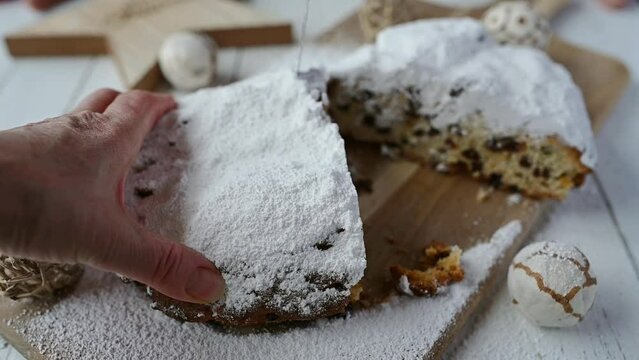 Cutting a slice of homemade Christmas stollen