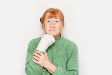 An elderly woman broke a finger on her hand and now hand is in a cast, the woman is sad because her hand is being treated for a long time at an older age and the woman cannot yet live fully