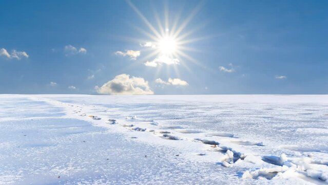 snowbound plain with human track at sunny winter day time lapse scene