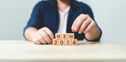 the essence of a fresh start in 2024. It features wooden blocks arranged to spell 2024 START,...