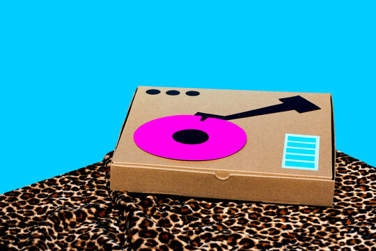 Music controller made on cardboard box over blue background