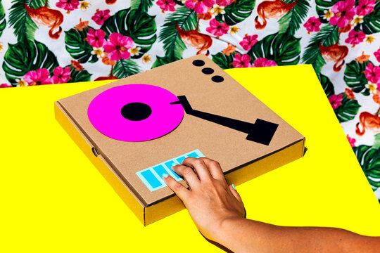 Woman using music controller made with cardboard box