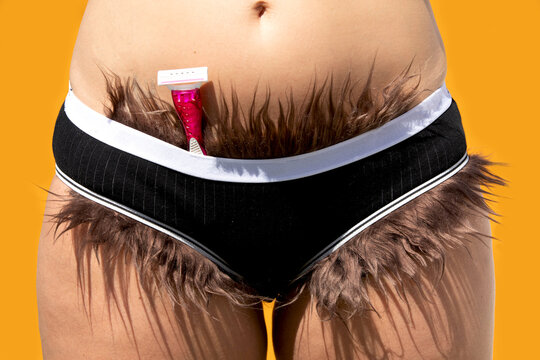 Woman with razor and pubic hair sticking out from panties