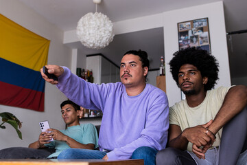Male friends spending leisure time at home