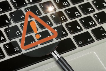 Red triangle warning sign on computer keyboard