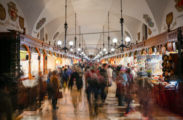 Kraków Poland Tuchhallen Stores with moving people  - obrazy, fototapety, plakaty
