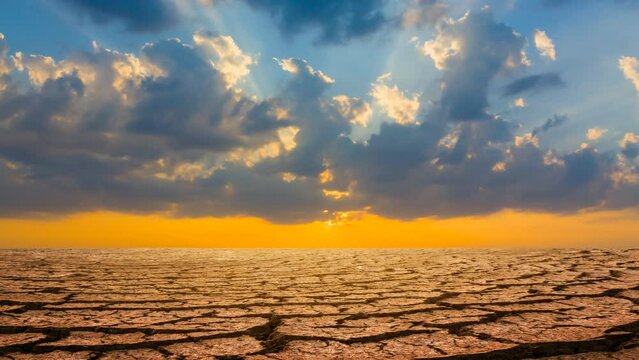 dry cracked waterless plain at the sunset, dramatic ecological disaster time lapse scene