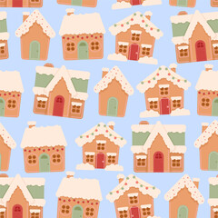 Christmas seamless pattern of gingerbread houses on a blue background
