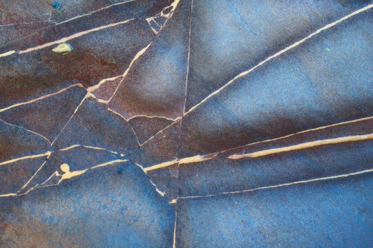 Textured blue and brown marble surface with natural patterns