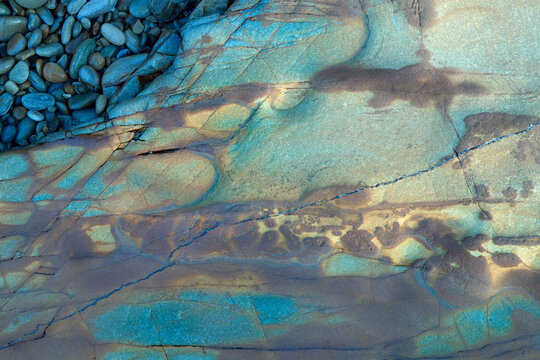 Colorful rock textures and pebbles at the beach