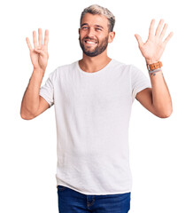 Young handsome blond man wearing casual t-shirt showing and pointing up with fingers number nine while smiling confident and happy.