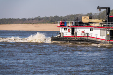 Detail of the stern of a pusher boat or tugboat churning the Mississippi river in Missouri with...