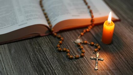  A wax candle goes out on the table where the Bible and rosary lie. Place of prayer for an Orthodox person.
