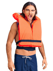 Young handsome man wearing nautical lifejacket winking looking at the camera with sexy expression,...
