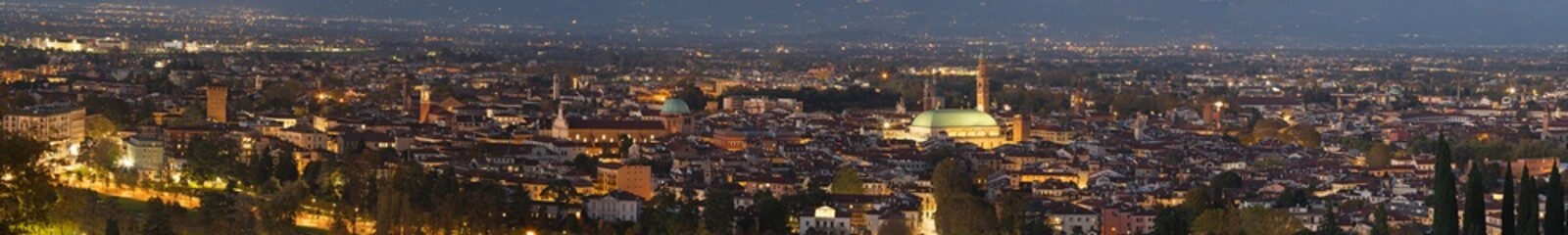 The cityscape of Vicenza at dusk.