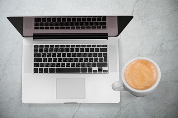 Laptop computer with blank screen on office desk