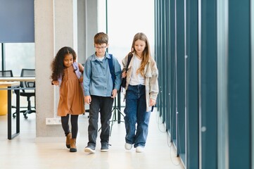 Fototapeta premium Portrait of kids standing in elementary school hallway