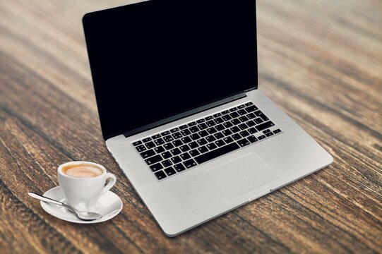 Laptop computer with blank screen on office desk