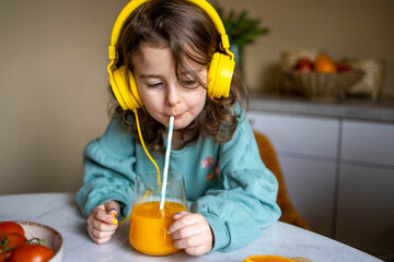Caucasian child having juice at home