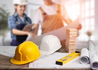 Engineer teams working together on construction site with house model