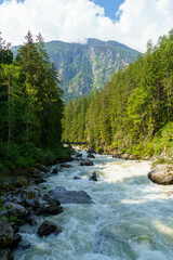 Fast flowing mountain river landscape. Summer time in Alps. Ötztal