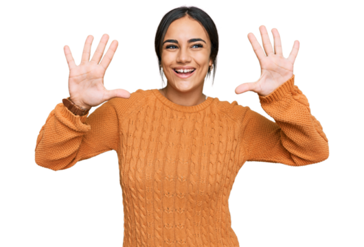 Young brunette woman wearing casual winter sweater showing and pointing up with fingers number ten while smiling confident and happy.