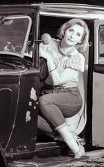 Attractive pin-up woman posing in a vintage car, Vinkovci, Croatia