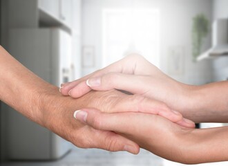 Caring elderly old grandma holding hand  to supporting